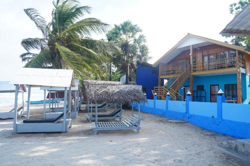 a house on the beach with a swing and a playground at Golden Beach Hotel & Restaurant in Trincomalee