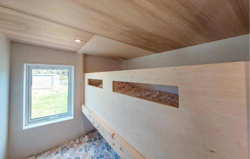 a tiny house with a built in book shelf at 2 Bedroom Beautiful Home In Ambon in Ambon