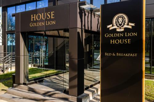 a sign for the golden lion house outside a building at Golden Lion House Bed&Breakfast in Rumia