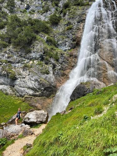 a person standing in front of a waterfall at Haus Auszeit in Buchau