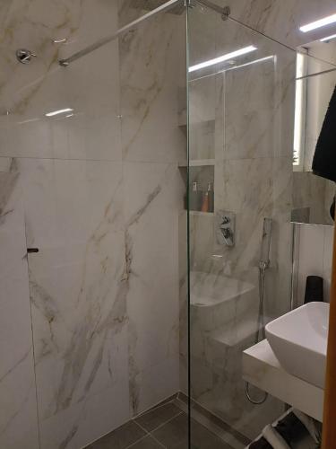 a bathroom with a shower and a sink at Cozy Summer House by the Beach in Polychrono