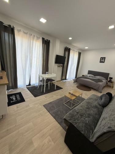 a living room with a couch and a table at EXCEPTIONNEL Studio VERSAILLES in Le Chesnay