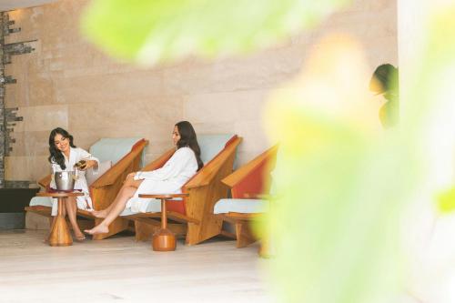 two women sitting in chairs in a room at W Punta de Mita in Punta Mita