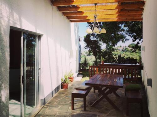 a wooden table and bench on a patio at Guesthouse Terra Africa in Windhoek