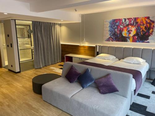 a hotel room with a bed and a couch at Ostend Hotel in Ostend