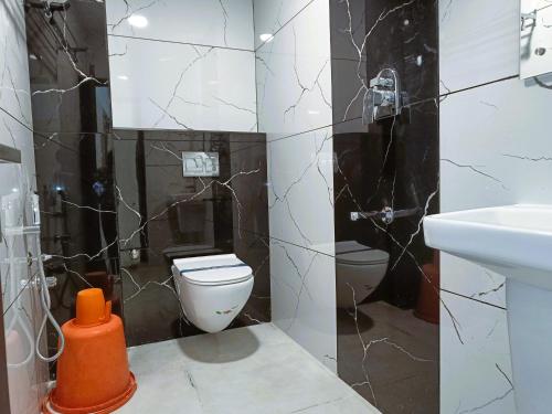 a bathroom with a toilet and a sink at Hotel Jeyam in Kanyakumari