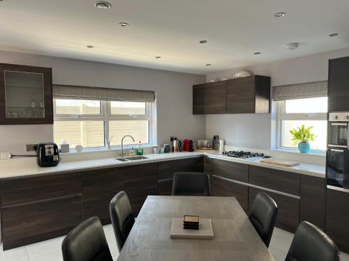 a kitchen with a table and chairs and a kitchen with a sink at Holiday Home in Leap in Leap