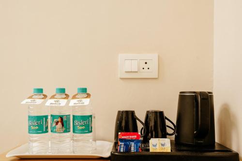 a group of water bottles sitting on a table at Daksh The Grand Goverdhan in Dwarka