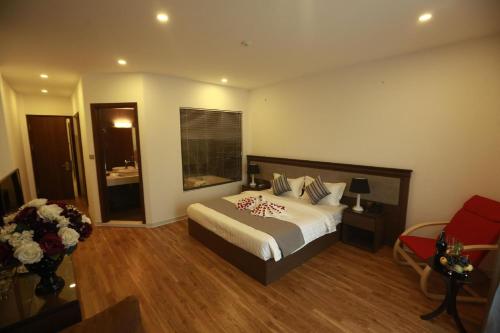 a hotel room with a bed and a window at Collection O Le Grand Hanoi hotel - The Tryst in Hanoi