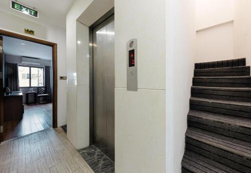 a elevator in a building with a stair case at Collection O Le Grand Hanoi hotel - The Tryst in Hanoi