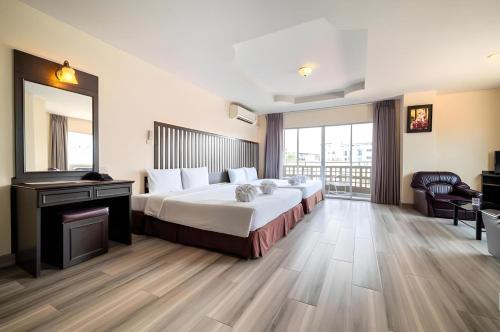a hotel room with a bed and a fireplace at Sunday JA Plus Hotel in Pattaya