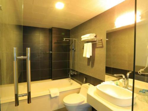 a bathroom with a toilet and a sink and a shower at Collection O Le Grand Hanoi hotel - The Tryst in Hanoi
