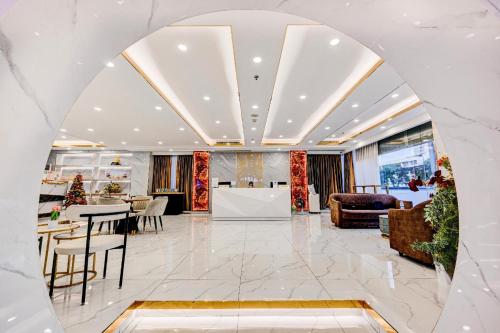 a lobby of a hotel with a table and chairs at Palette The Travellers Hotel Bangkok in Bangkok