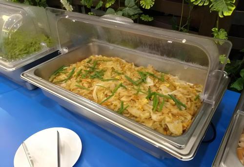 a casserole dish of food on a table at Palette The Travellers Hotel Bangkok in Bangkok