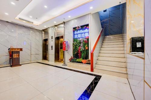 a lobby of a building with a large window with flowers at Palette The Travellers Hotel Bangkok in Bangkok