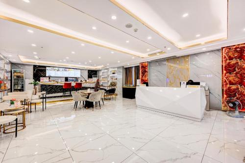 a restaurant with tables and chairs and a bar at Palette The Travellers Hotel Bangkok in Bangkok