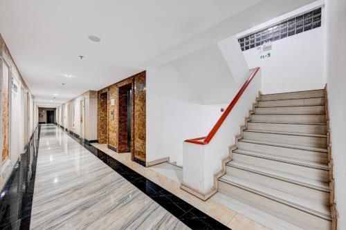 an empty hallway with stairs in a building at Palette The Travellers Hotel Bangkok in Bangkok