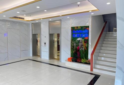 a lobby with a large flower arrangement on the wall at Palette The Travellers Hotel Bangkok in Bangkok