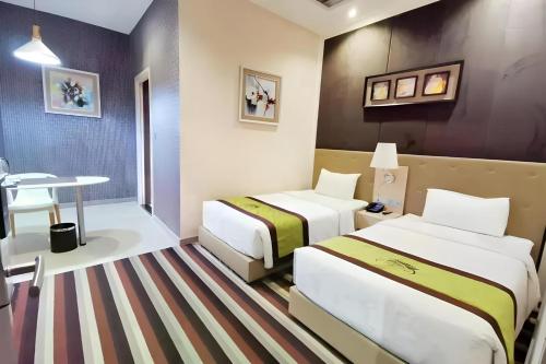 Postel nebo postele na pokoji v ubytování Capital O 75451 Podstel Hostel Bangkok