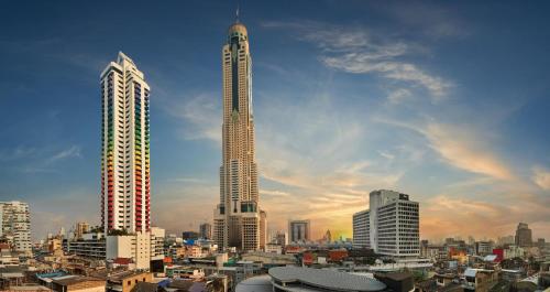 a view of a city with a tall building at OYO 75446 Travis Inthamara 49 in Bangkok