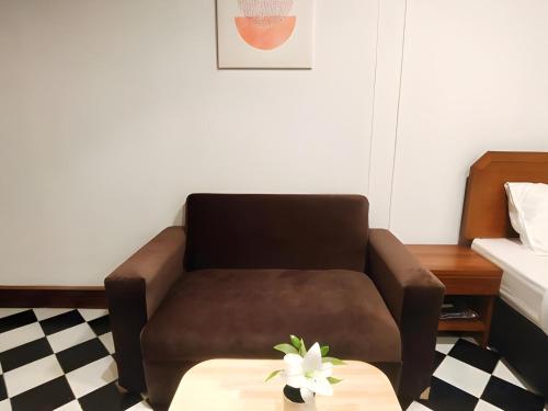 a living room with a couch and a coffee table at OYO 75446 Travis Inthamara 49 in Bangkok