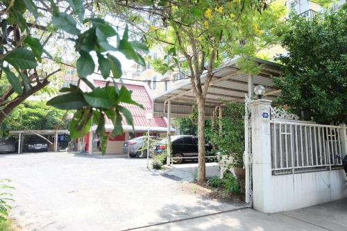 a house with a car parked in a driveway at OYO 75429 - 101 Place Navanakorn in Bangkok