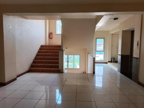 an empty hallway with stairs in a building at Grandview Condominia in Bangkok