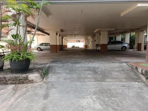 an empty parking garage with cars parked in it at Grandview Condominia in Bangkok