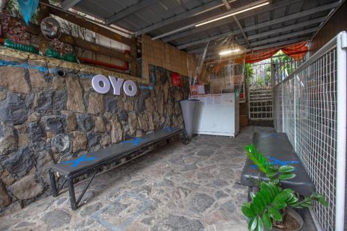 a room with a bench and a stone wall at OYO 588 Sunrock Resort in Antipolo