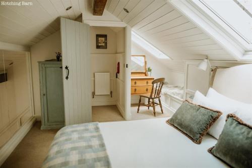 a bedroom with a bed and a desk in a room at Lyme Tree Farm Cottages - Hotching Barn and Knockstone Cottage in Tideswell