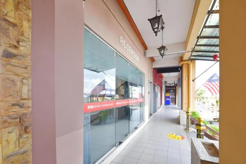 a building with a large window on the side of it at Hotel O Destiny Riverside Hotel in Kota Bharu