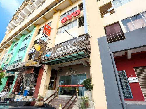 a hotel with a sign on the front of it at Hotel O Destiny Riverside Hotel in Kota Bharu