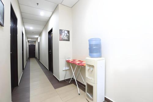 a corridor of a hospital hallway with a blue object on the wall at Hotel O Destiny Riverside Hotel in Kota Bharu
