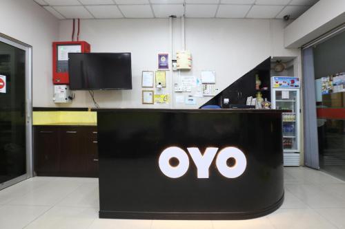 a sign for an ovo store in a store at Hotel O Destiny Riverside Hotel in Kota Bharu