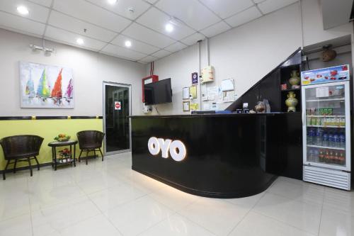 a lobby of a store with a ovo counter and chairs at Hotel O Destiny Riverside Hotel in Kota Bharu