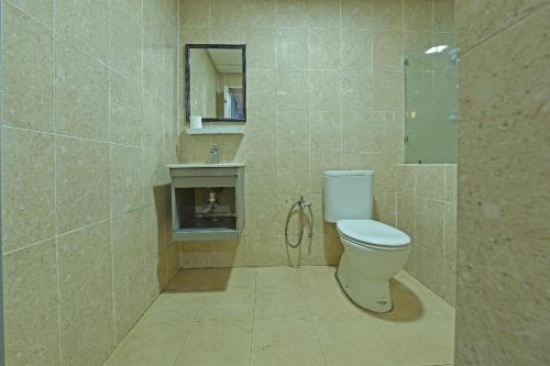 a bathroom with a toilet and a sink at Hotel O Fajar Baru Boutique Hotel in Kuala Terengganu