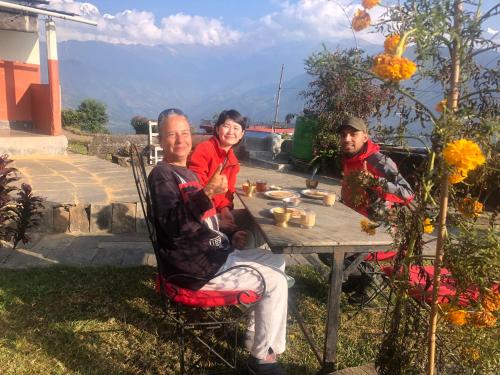 a man and a woman sitting at a table at Anne Homestay in Pokhara