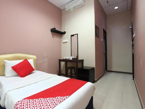 a hotel room with a bed and a small table at Hotel O Destiny Riverside Hotel in Kota Bharu