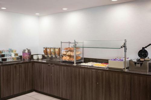 a bakery counter with donuts and pastries on it at Residence Inn Pleasant Hill Concord in Pleasant Hill