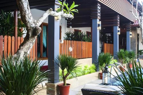 a house with plants in front of it at Sunday Telaga Terrace Boutique Resort in Pantai Cenang