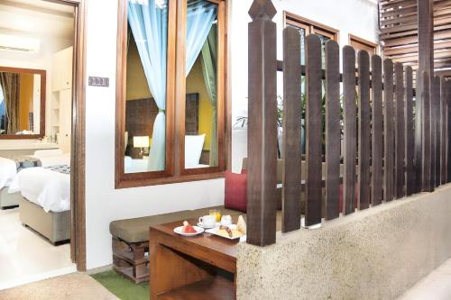 a room with a table and a mirror at Sunday Telaga Terrace Boutique Resort in Pantai Cenang