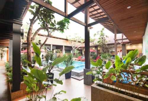 a courtyard with plants and a swimming pool at Sunday Telaga Terrace Boutique Resort in Pantai Cenang