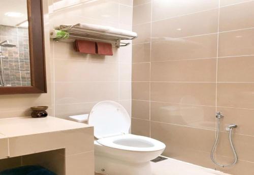 a bathroom with a toilet and a sink and a shower at Sunday Telaga Terrace Boutique Resort in Pantai Cenang