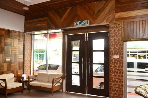 a lobby of a building with a sign on the door at Hotel O Five 2 in Kota Kinabalu