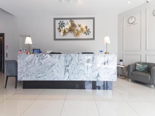 a marble counter in a living room with a couch at Yootel Boutique Hotel in Kajang