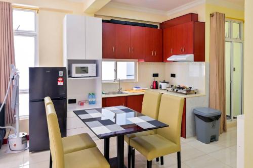 a kitchen with a table and chairs and a refrigerator at Air Residence 10813 in Hulhumale