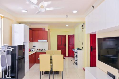a kitchen with red cabinets and a black refrigerator at Air Residence 10813 in Hulhumale