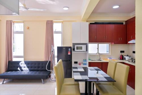 a kitchen with a table and chairs and a dining room at Air Residence 10813 in Hulhumale