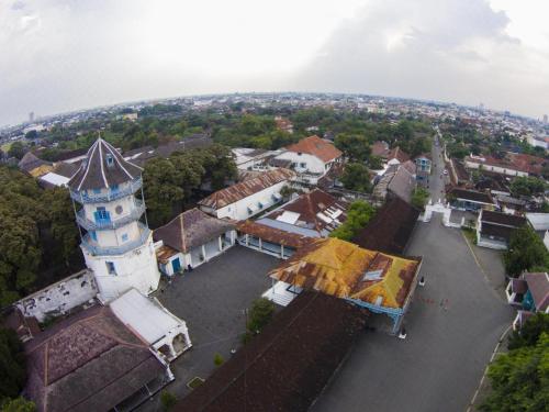an aerial view of a town with a tower at Collection O Jalan Slamet Riyadi Near Kampung Batik Kauman Formerly Hotel Grand Kota in Solo