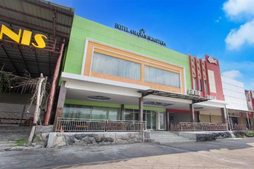 a multicolored building with stairs in front of it at Hotel O Jalan Slamet Riyadi Near Bandara Adi Soemarmo Formerly Amanah Sejahtera in Solo